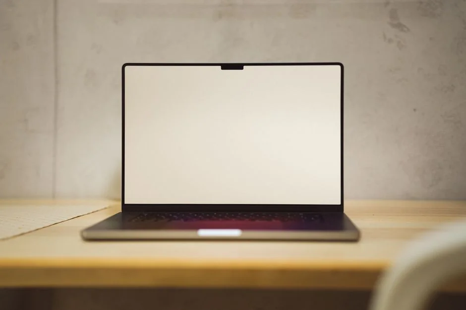 A laptop screen showing pictures in a dimly lit room, highlighting digital era browsing.